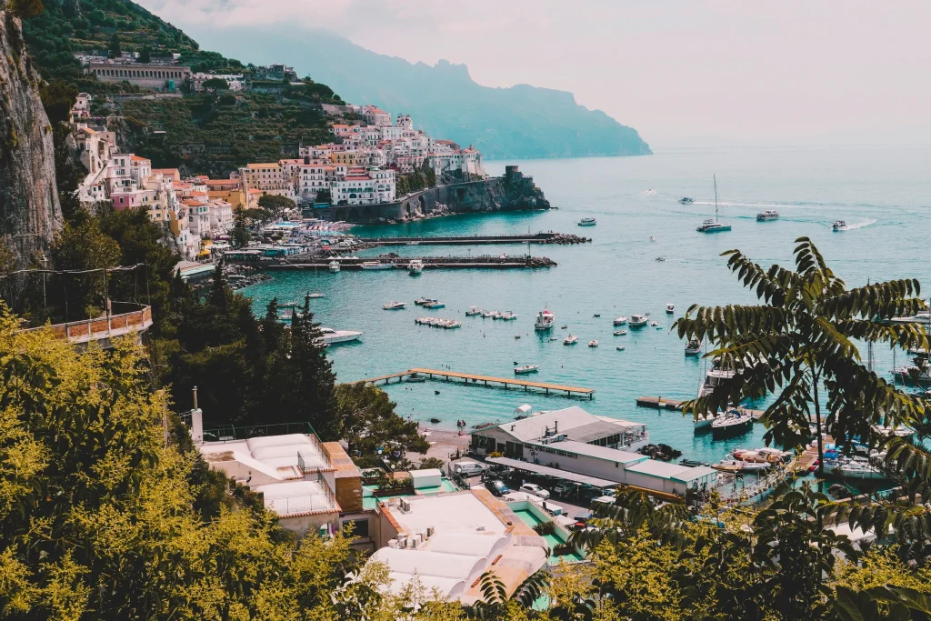 A quiet bay on the Amalfi Coast with small boats and pine trees