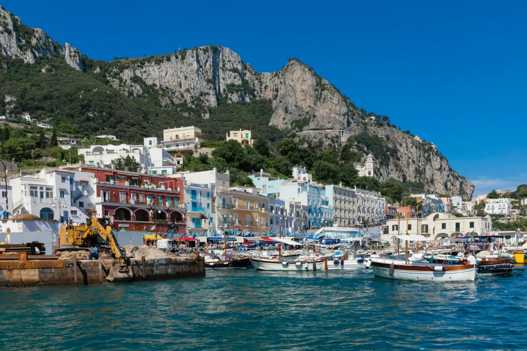 The harbour of Marina Grande on Capri with boats below the island cliffs