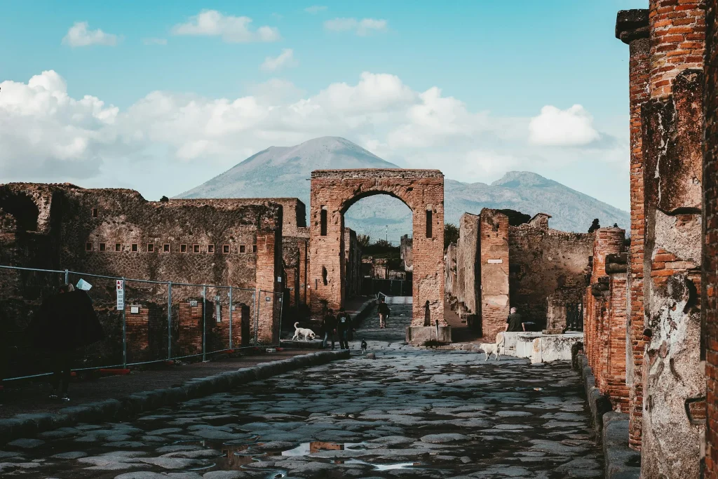 A paved street in the Pompeii excavations with Mount Vesuvius in the distance