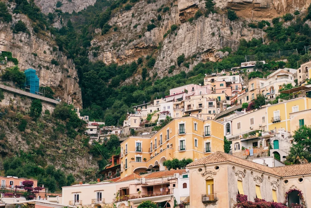 The pastel houses of Positano stacked above the beach on the Amalfi Coast