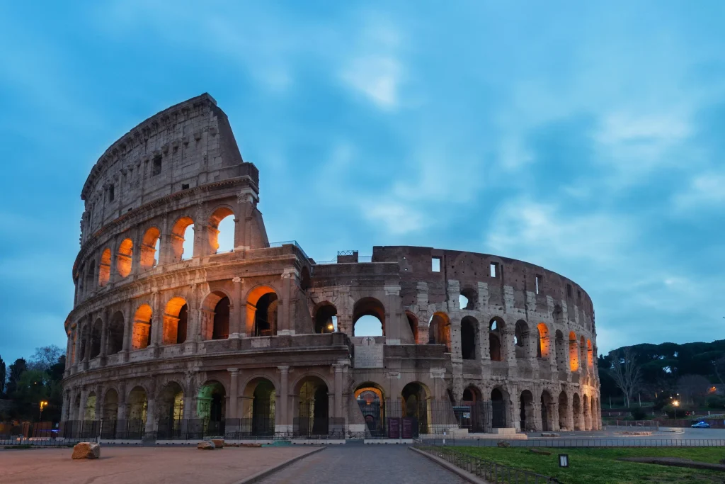 The Colosseum in Rome lit from inside at blue hour
