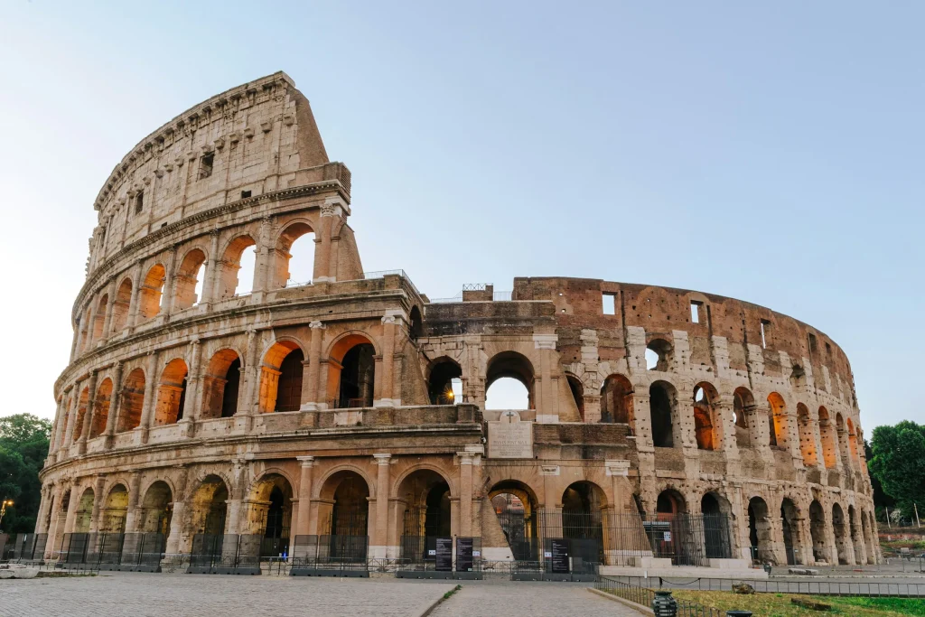 The Colosseum in Rome at golden hour under a clear sky