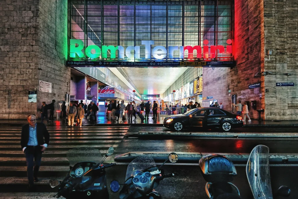 The lit entrance sign of Roma Termini station at night