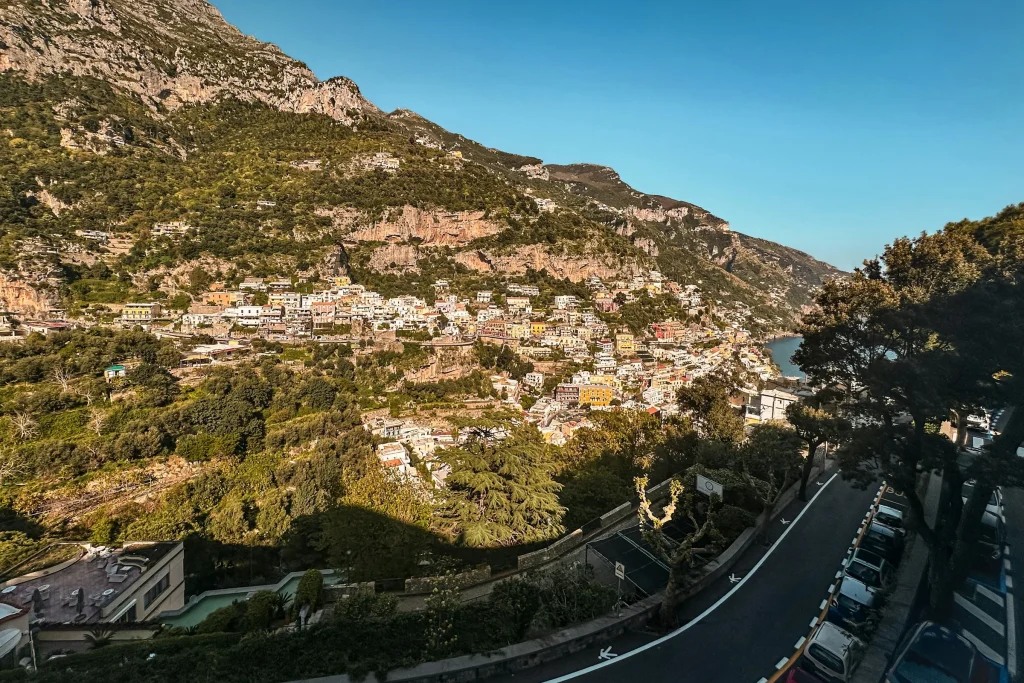 The coast road winding below a village on the Amalfi Coast, seen from above